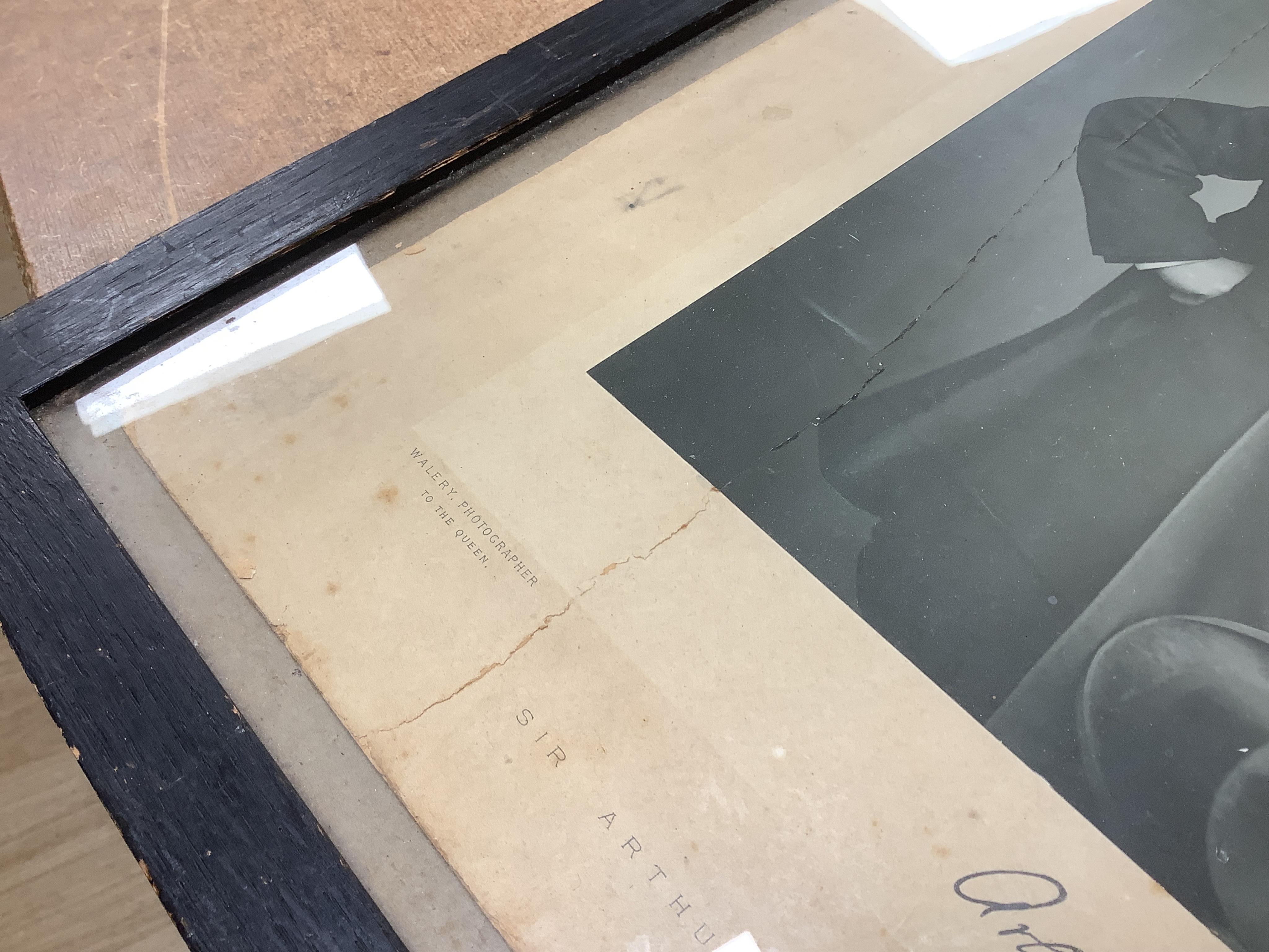 A Gilbert and Sullivan Opera model theatre, with printed card figures from the Mikado, together with a portrait photograph of Sir Arthur Sullivan loosely contained within a stained wood frame, the photograph is unmounted